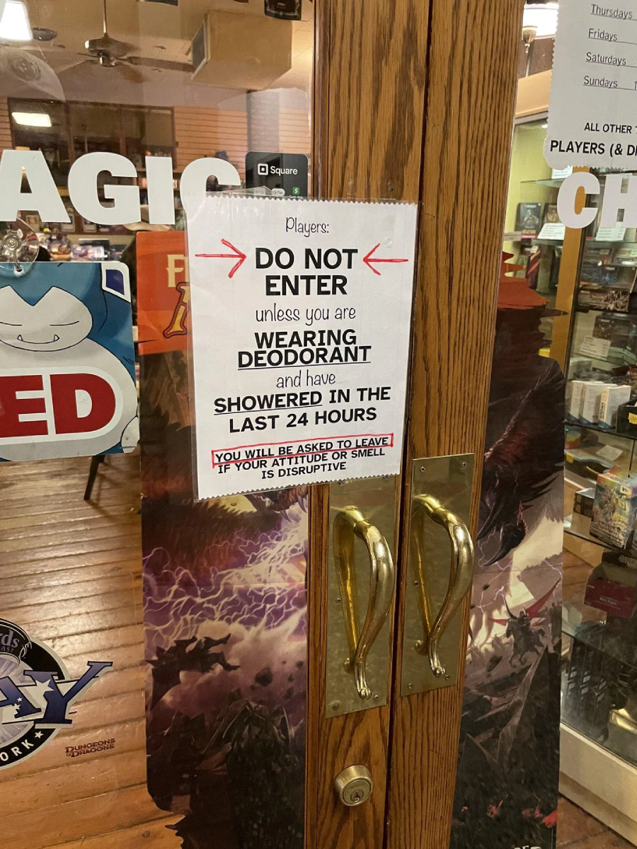 A sign on a glass door reads: "Players: DO NOT ENTER unless you are WEARING DEODORANT and have SHOWERED IN THE LAST 24 HOURS. You will be asked to leave if you disrupt or smell.