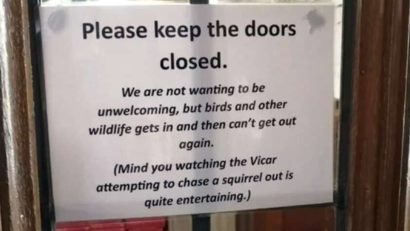 A sign on a glass door reads: "Please keep the doors closed. We are not wanting to be unwelcoming, but birds and other wildlife gets in and then can’t get out again.