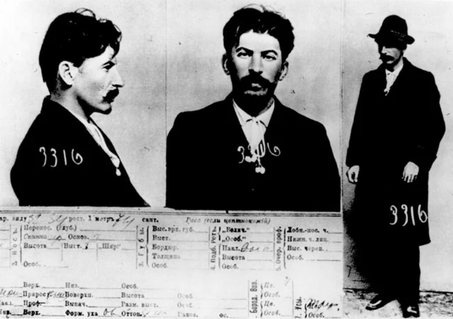 Black-and-white mugshot with three views of a man in a dark suit, including profile, front, and full-body. Handwritten number 3316 appears on his jacket. Below are documents with handwritten Russian text.