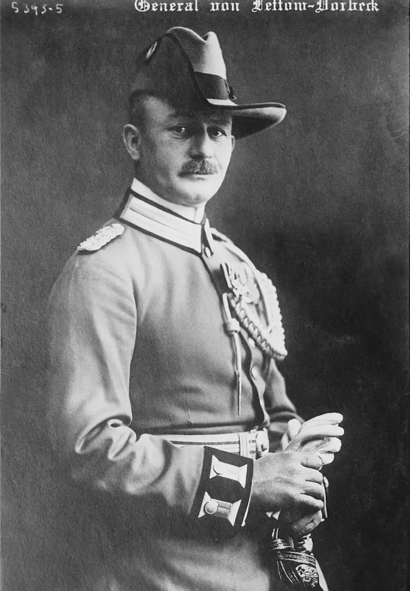 Black-and-white portrait of a man in a decorated military uniform and hat, standing and holding a sword, with text "General von Lettow-Vorbeck" at the top of the image.