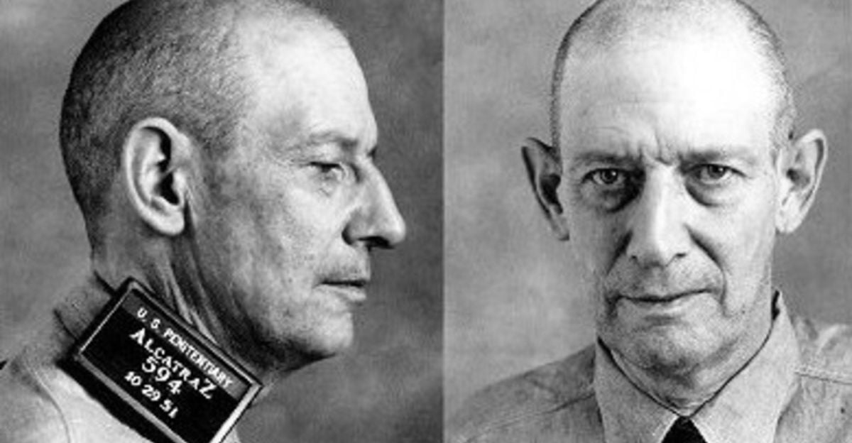 Black and white mugshot of a middle-aged man with short hair, shown in both side and front view, wearing a collared shirt. A placard reading "U.S. Penitentiary Alcatraz 594 10-29-31" appears in the side profile.