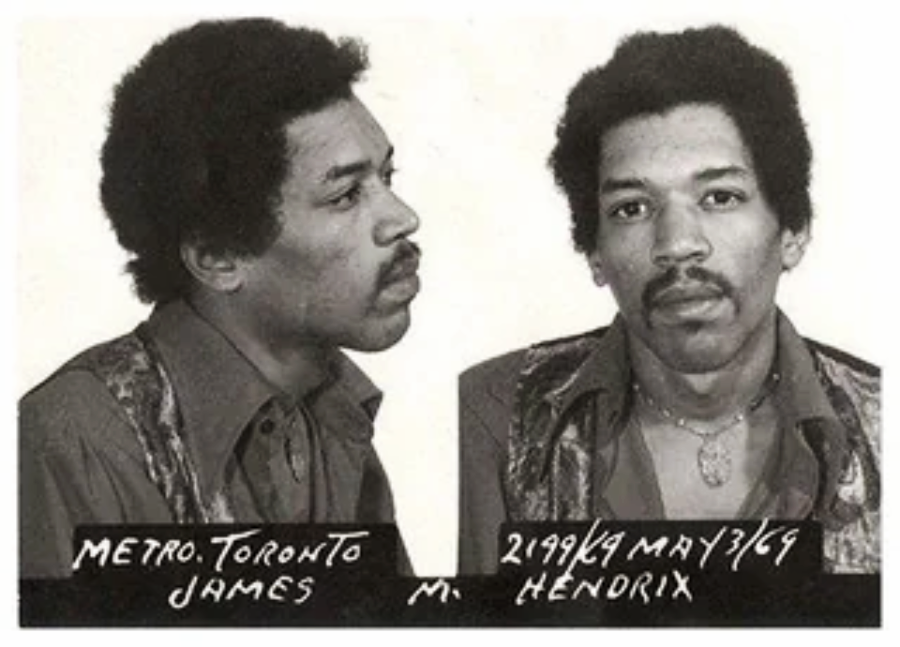 Black and white mugshot photo of a man with short curly hair, wearing a patterned shirt. Text below reads: "METRO. TORONTO JAMES M. HENDRIX 2199/69 MAY 3/69".