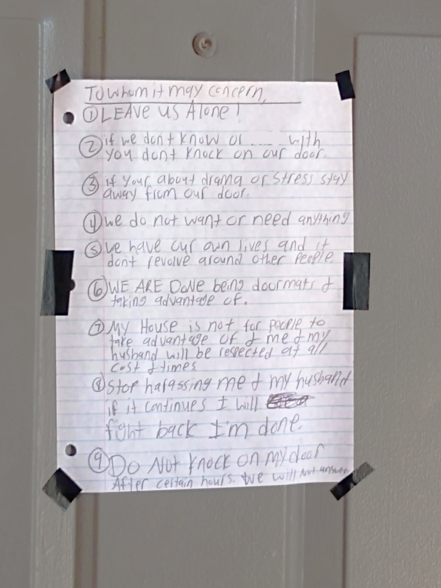 A handwritten note taped to a door lists nine rules in black ink, including requests for privacy, not to knock, and not to harass the residents. The note emphasizes boundaries and respect for the occupants.