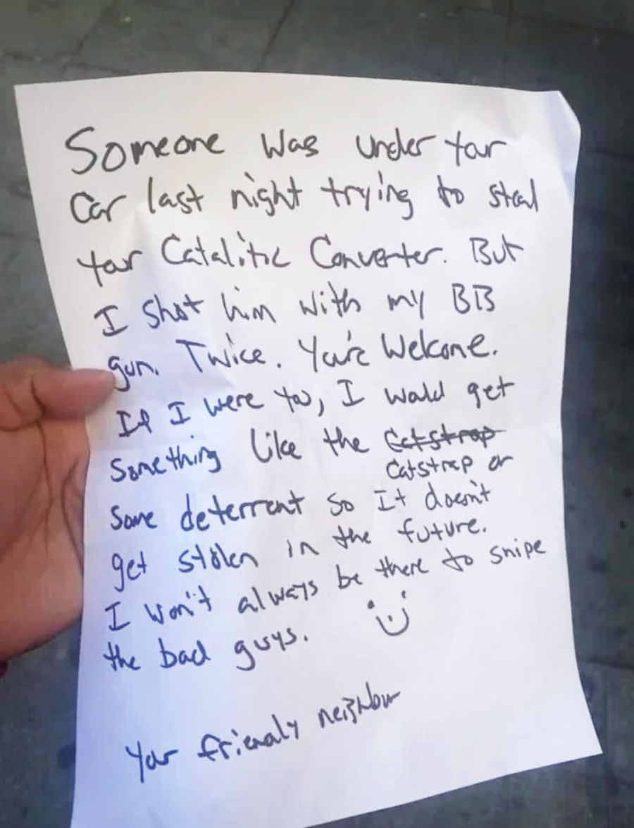 A handwritten note reads: “Someone was under your car last night trying to steal your catalytic converter. But I shot him with my BB gun. Twice. You’re welcome. Get deterrent so it doesn’t get stolen. Your friendly neighbor.”