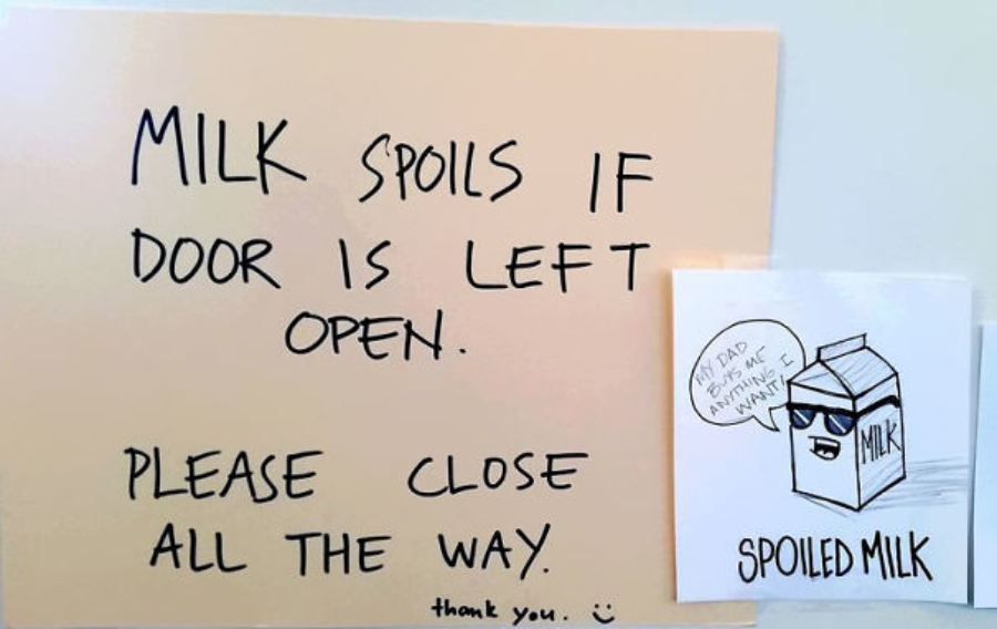 A sign reads, "MILK spoils if door is left open. Please close all the way. thank you. :)" Next to it is a drawing of a milk carton saying, "I'm bad because someone left me open," labeled "SPOILED MILK.