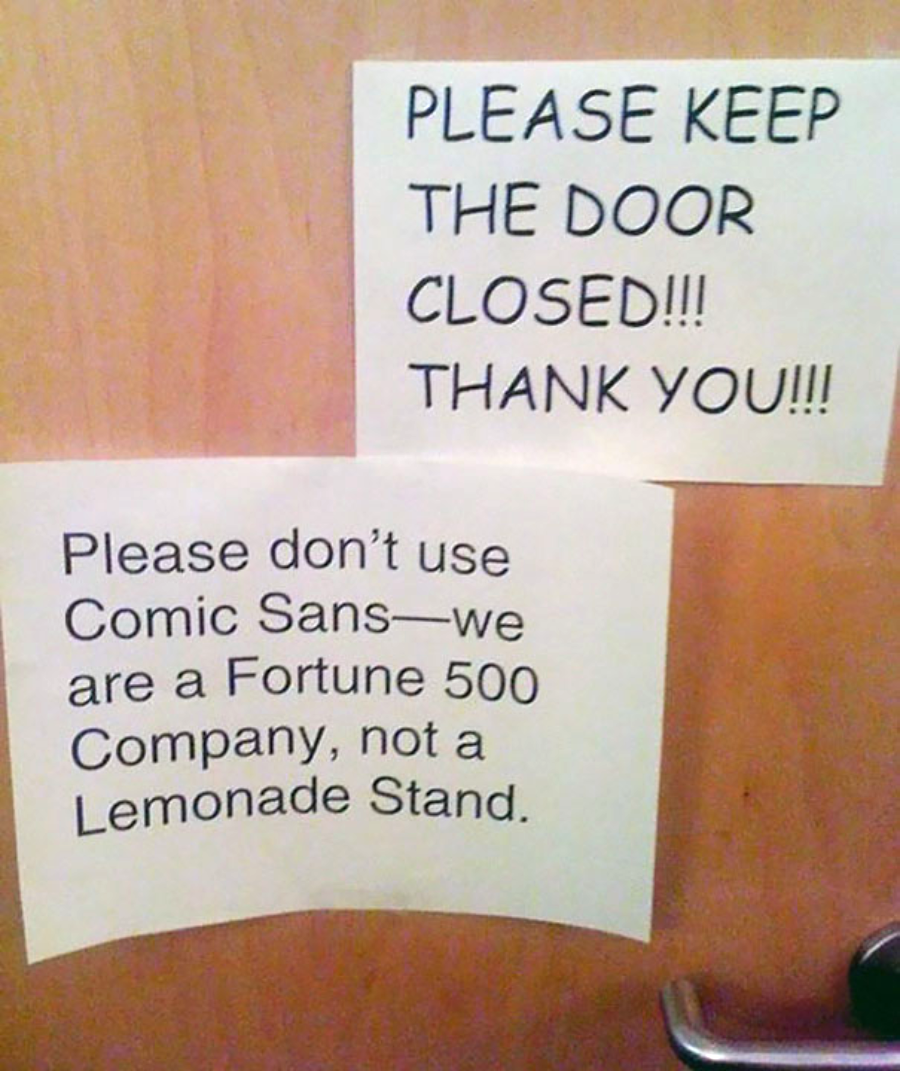 Two printed signs on a door: one says, "PLEASE KEEP THE DOOR CLOSED!!! THANK YOU!!!" The other says, "Please don't use Comic Sans—we are a Fortune 500 Company, not a Lemonade Stand.