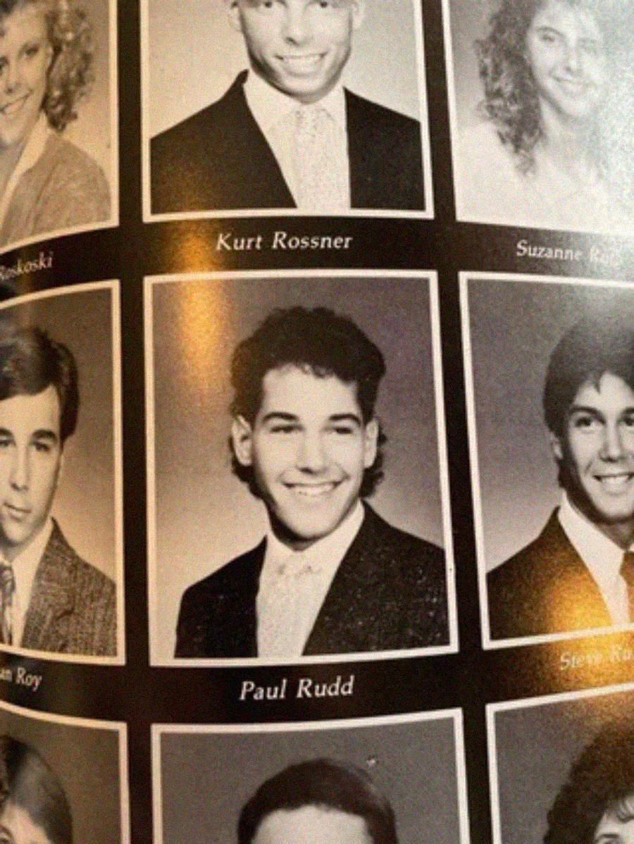 A black-and-white yearbook page features several portrait photos of high school students, including one labeled "Paul Rudd," showing a young man smiling and wearing a suit and tie.