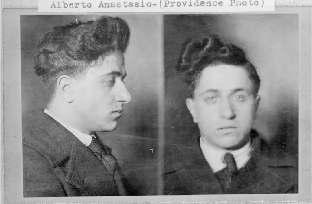 Black and white mugshot photo showing a man with dark, wavy hair in two views: profile on the left and front-facing on the right. A label above reads “Alberto Anastasio (Providence Photo).”