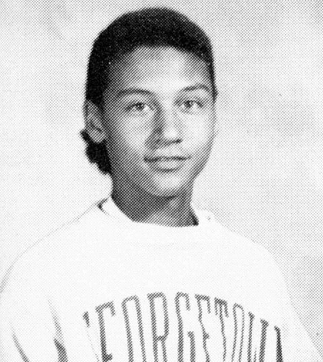 Black and white yearbook photo of a young person with short curly hair, wearing a sweatshirt with "GEORGETOWN" printed on it, looking directly at the camera and smiling slightly against a plain background.