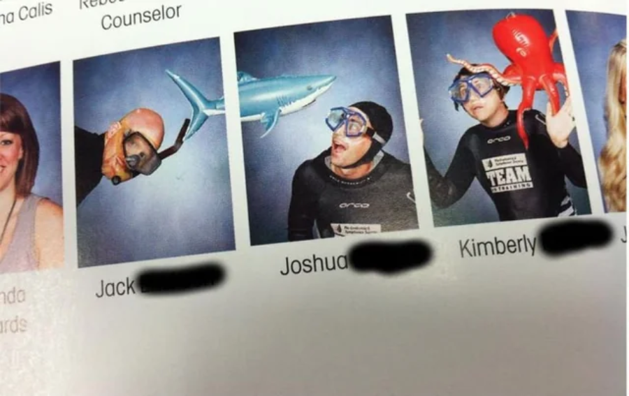 Three people pose in wetsuits, goggles, and snorkels for school photos. One wears an octopus hat, one pretends to be attacked by a toy shark, and another wears a lobster hat. All appear playful and humorous.