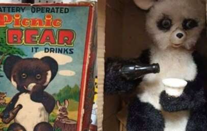 A vintage toy box labeled "Battery Operated Picnic Bear It Drinks" is shown next to a photo of a black and white bear toy holding a cup and a bottle, posed to look like it is pouring a drink.