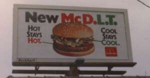 A billboard advertises the McDonald's McDLT burger with the text "New McDLT. Hot stays hot. Cool stays cool." and an image of the burger. The McDonald's logo appears in the bottom right corner.