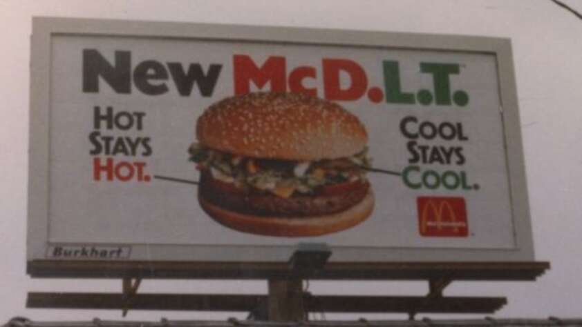 A billboard advertises the McDonald's McDLT burger with the text "New McDLT. Hot stays hot. Cool stays cool." and an image of the burger. The McDonald's logo appears in the bottom right corner.