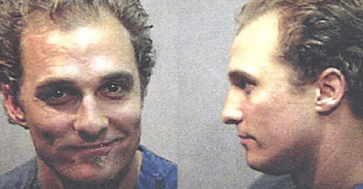 Two mugshot photos of a man with light skin and short, wavy hair; one shows his face smiling slightly, the other is a side profile. Both images have neutral backgrounds.