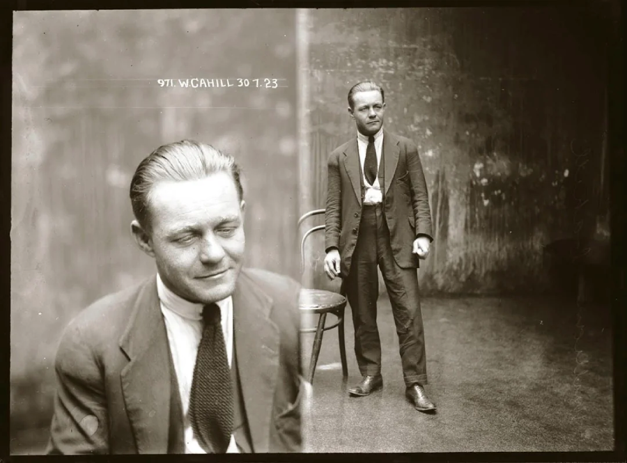 A sepia-toned, vintage mugshot shows a man in a suit and tie. One view is a close-up of his face with eyes closed, while the other shows him standing beside a chair in a sparse room, looking straight ahead.