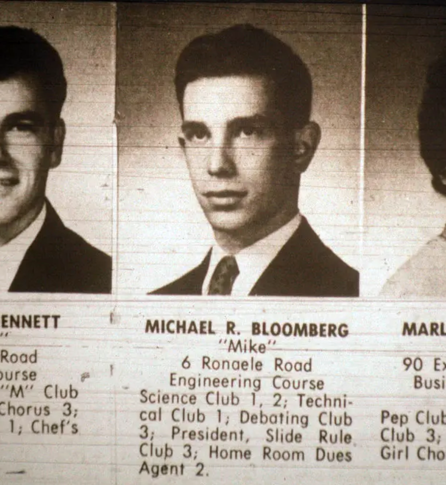 A black-and-white yearbook photo of a young man labeled “Michael R. Bloomberg ‘Mike’.” His activities and address are listed below the portrait. Photos and brief descriptions of two other students appear partially on either side.