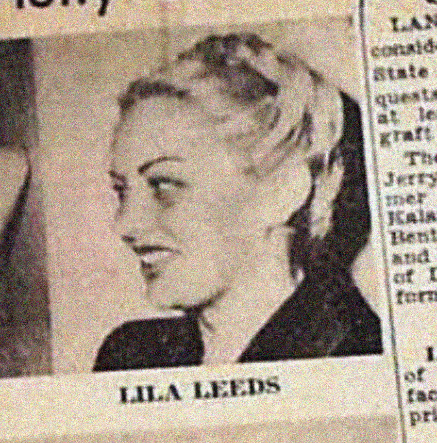 A newspaper clipping shows a black-and-white photo of a woman with light hair styled up, facing left. Below the image, the name “LILA LEEDS” is printed in bold capital letters. Text columns appear on the right edge.