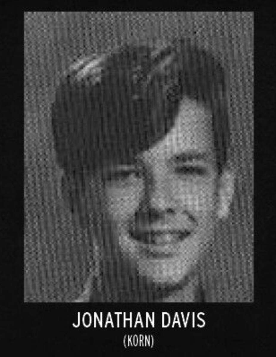 A black-and-white yearbook-style portrait of a young person with medium-length dark hair, smiling slightly. Text below the image reads "JONATHAN DAVIS (KORN).