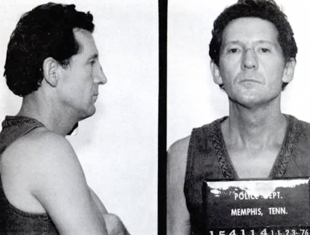 A black-and-white mugshot photo showing a man in a sleeveless shirt, facing sideways in one frame and forward in another, holding a sign that reads "POLICE DEPT. MEMPHIS, TENN.