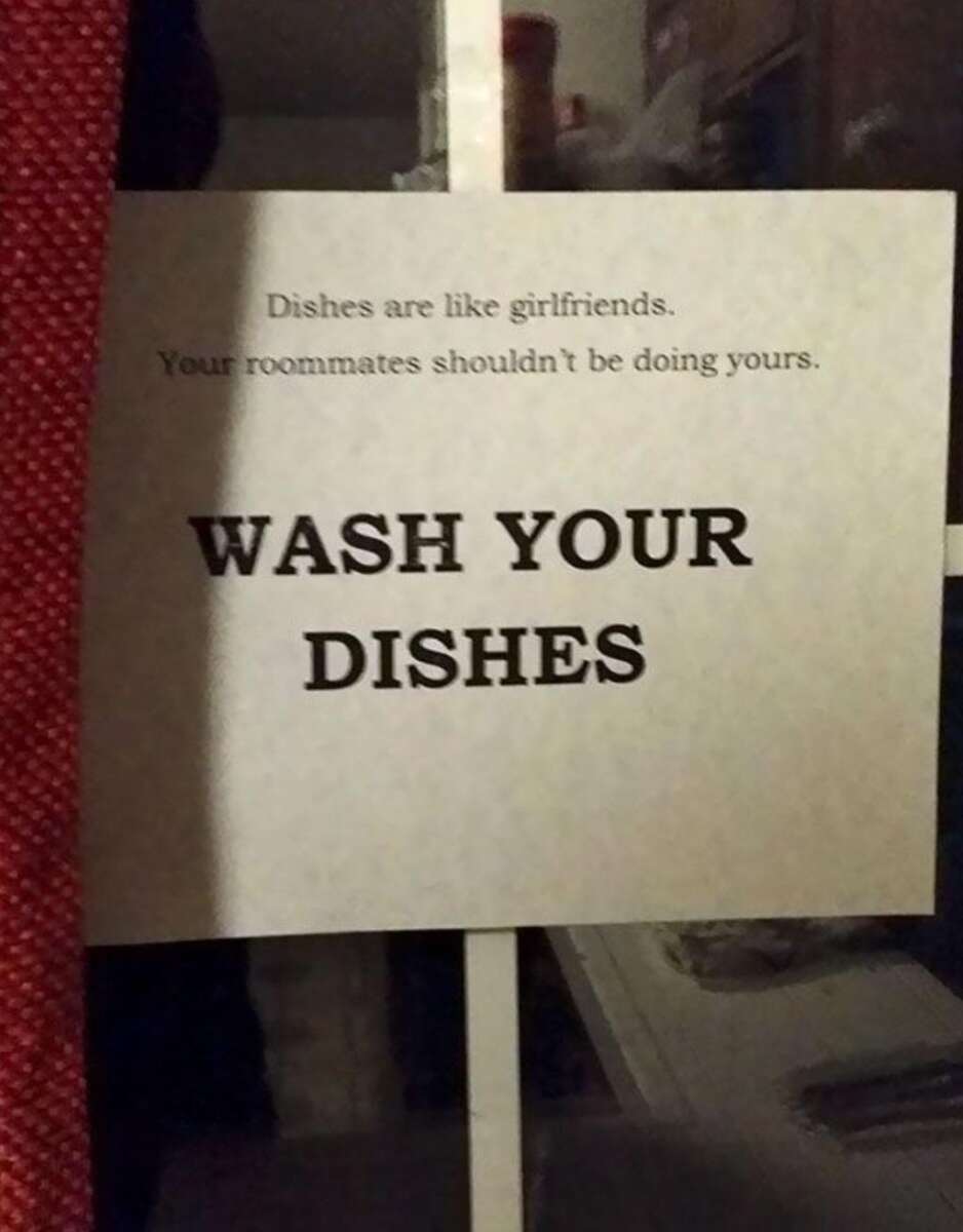 A printed sign reads: "Dishes are like girlfriends. Your roommates shouldn’t be doing yours. WASH YOUR DISHES" and is taped to a window.
