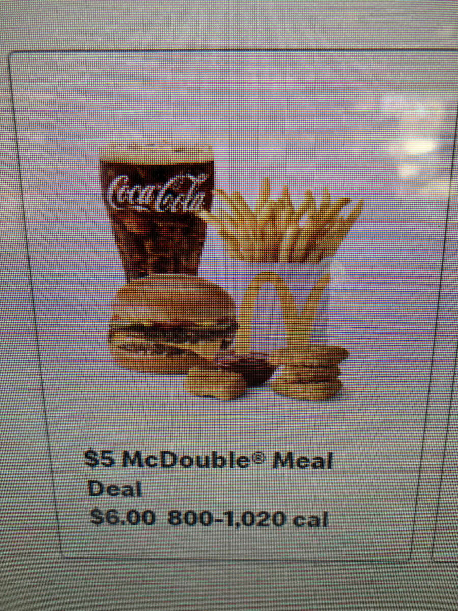 A $5 McDouble Meal featuring a burger, fries, four chicken nuggets with dipping sauce, and a cup of Coca-Cola. The meal is advertised as $6.00 and contains 800–1,020 calories.