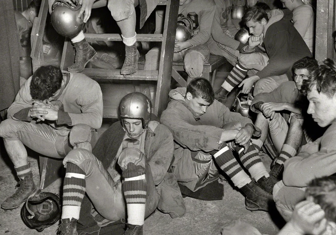 A group of men sitting on the ground