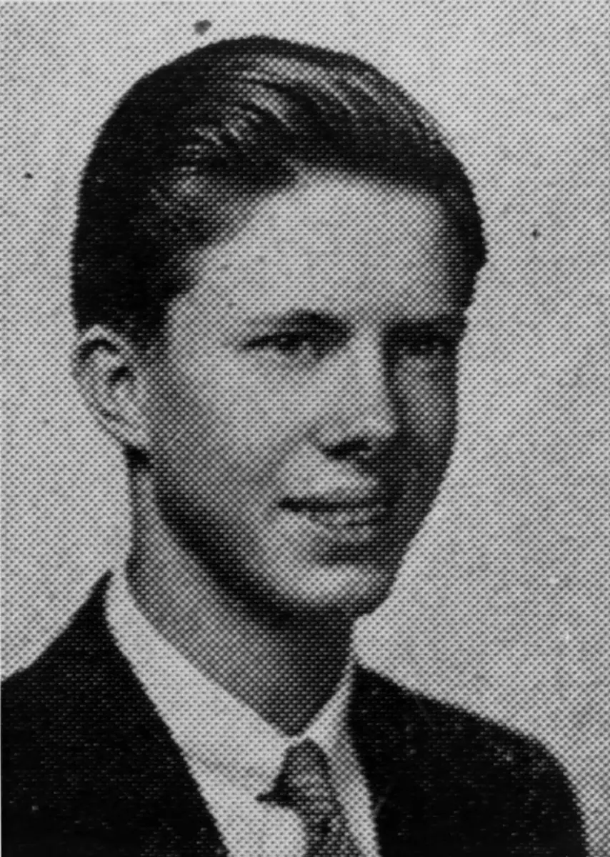 Black-and-white yearbook photo of a young man with neatly combed hair, wearing a suit, tie, and collared shirt, posed and looking slightly to the side with a neutral expression.