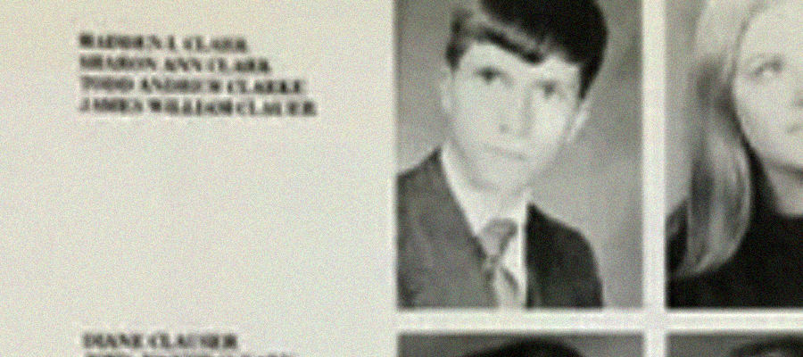 A blurry, black-and-white yearbook photo of a young man in a suit and tie, with text in the upper left corner and part of another portrait partially visible on the right.