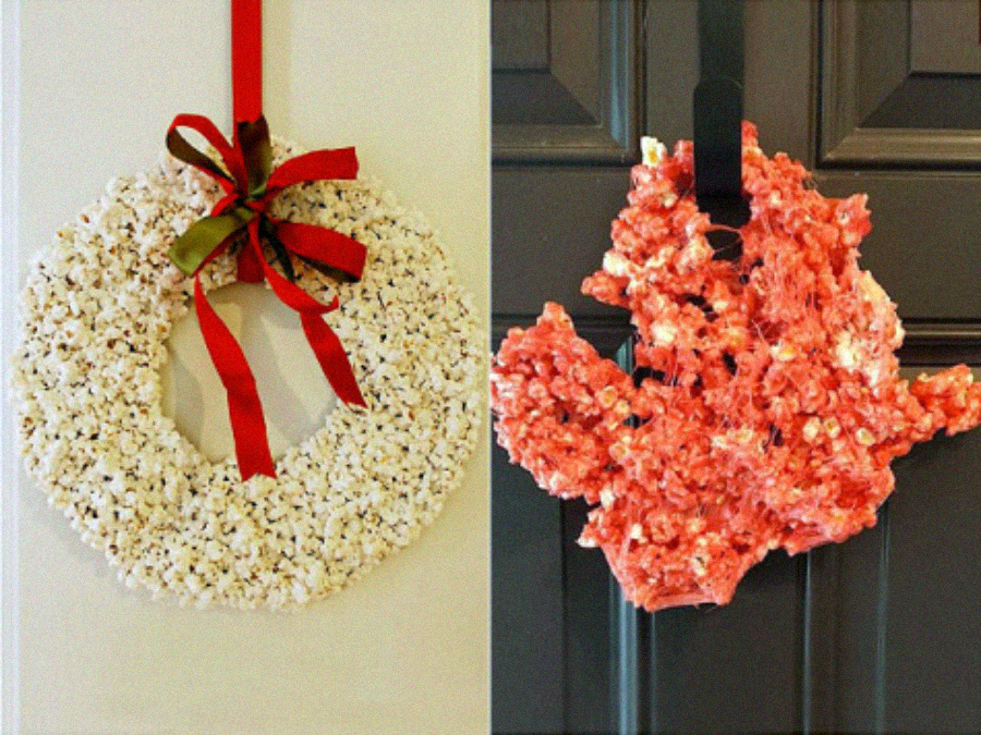 Two wreaths made of popcorn hang on doors. The left wreath is white, round, and decorated with red and green ribbons. The right wreath is shaped like Texas, pinkish-red in color, and hangs from a black ribbon.