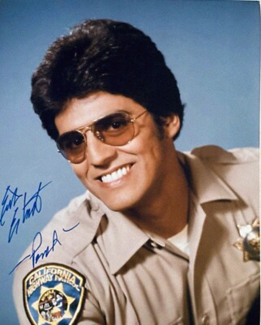 A man in a tan police uniform with a California Highway Patrol badge smiles at the camera. He has dark hair, wears aviator sunglasses, and has autographs on the photo. The background is light blue.