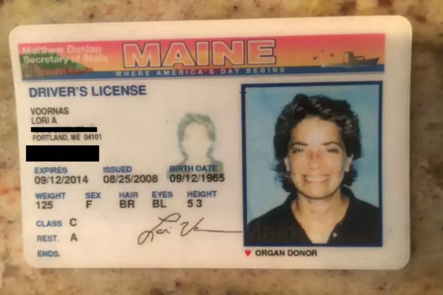 A Maine driver’s license for Lori A. Voornas showing her photo, personal details (partially redacted), organ donor status, and the state’s orange and blue design. The license expires on 09/12/2014.