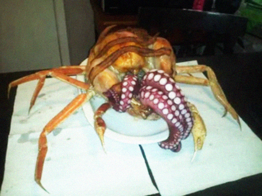 A cooked crab with large octopus tentacles spilling out sits on a plate atop white napkins on a table, creating a bizarre and unusual seafood presentation.