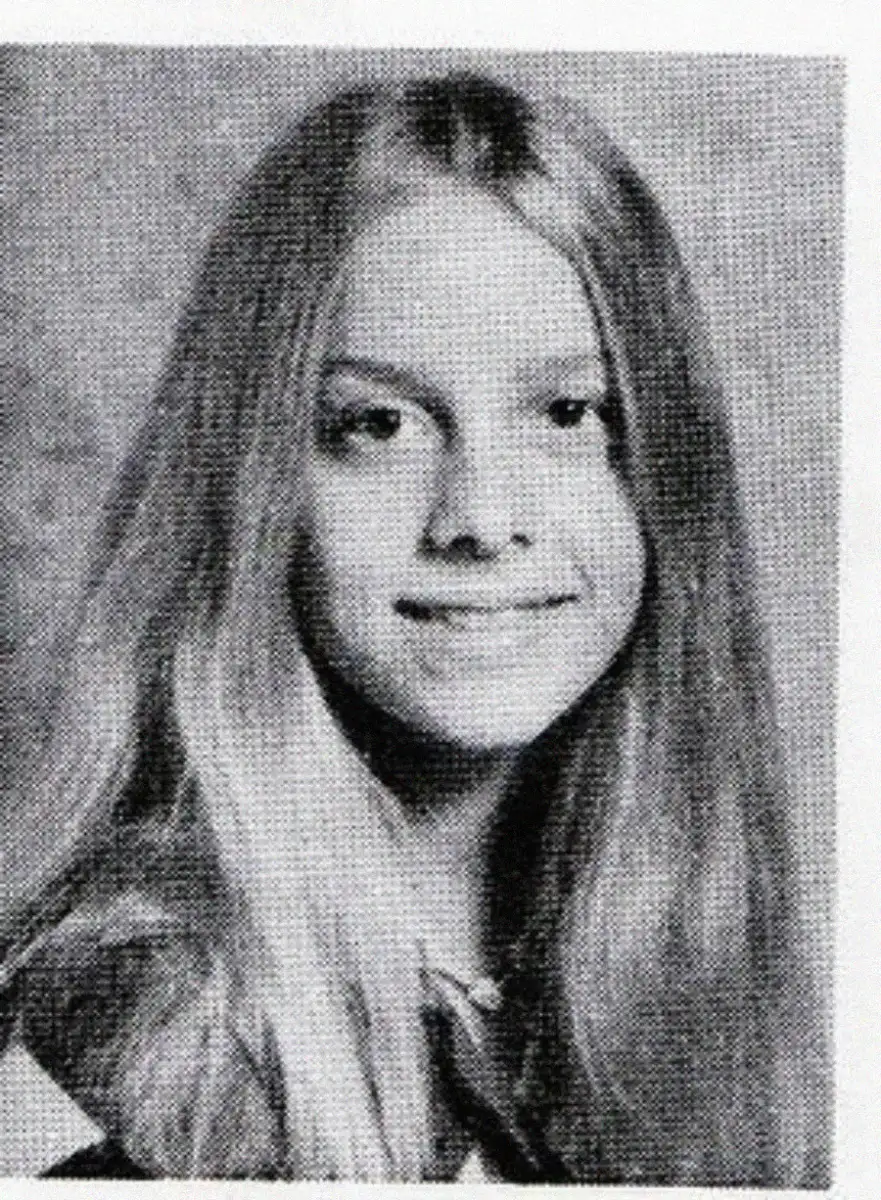 Black and white yearbook photo of a young girl with long, straight hair, smiling gently at the camera against a neutral background.