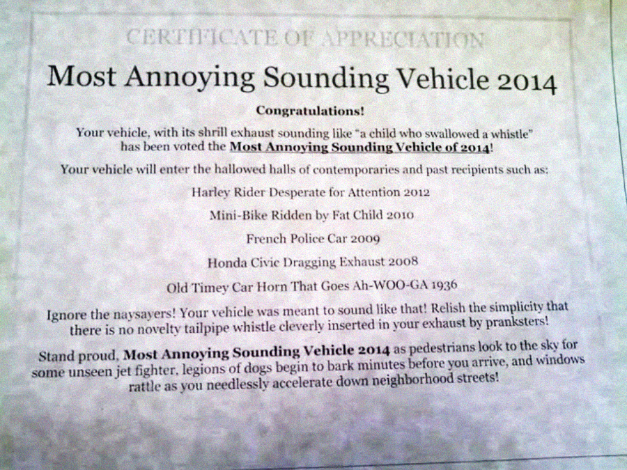 A certificate titled "Most Annoying Sounding Vehicle 2014" congratulating the winner. It lists past winners and encourages embracing the notoriety of having a noisy vehicle, with playful and humorous language.