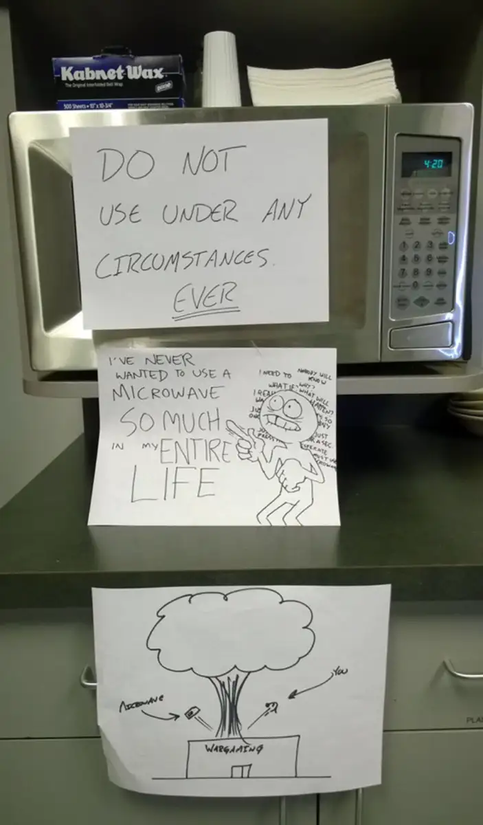 A microwave with large handwritten signs on it: "DO NOT USE UNDER ANY CIRCUMSTANCES. EVER." Below, a cartoon expresses frustration about not using the microwave. A third drawing shows a nuclear explosion labeled "VAPORIZATION.