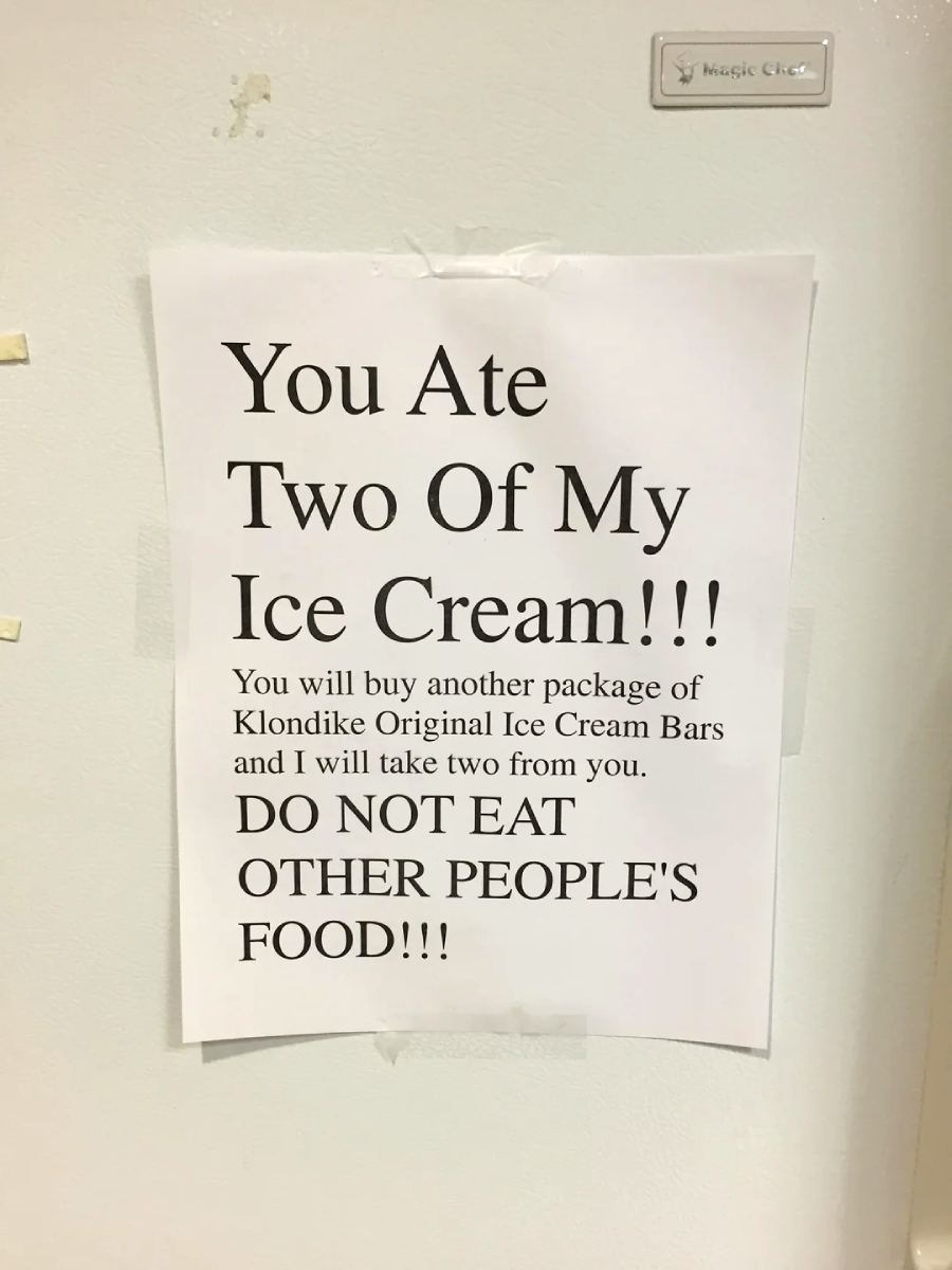 A printed sign taped to a fridge reads: "You ate two of my ice cream!!! You will buy another package of Klondike Original Ice Cream Bars and I will take two from you. DO NOT EAT OTHER PEOPLE'S FOOD!!!