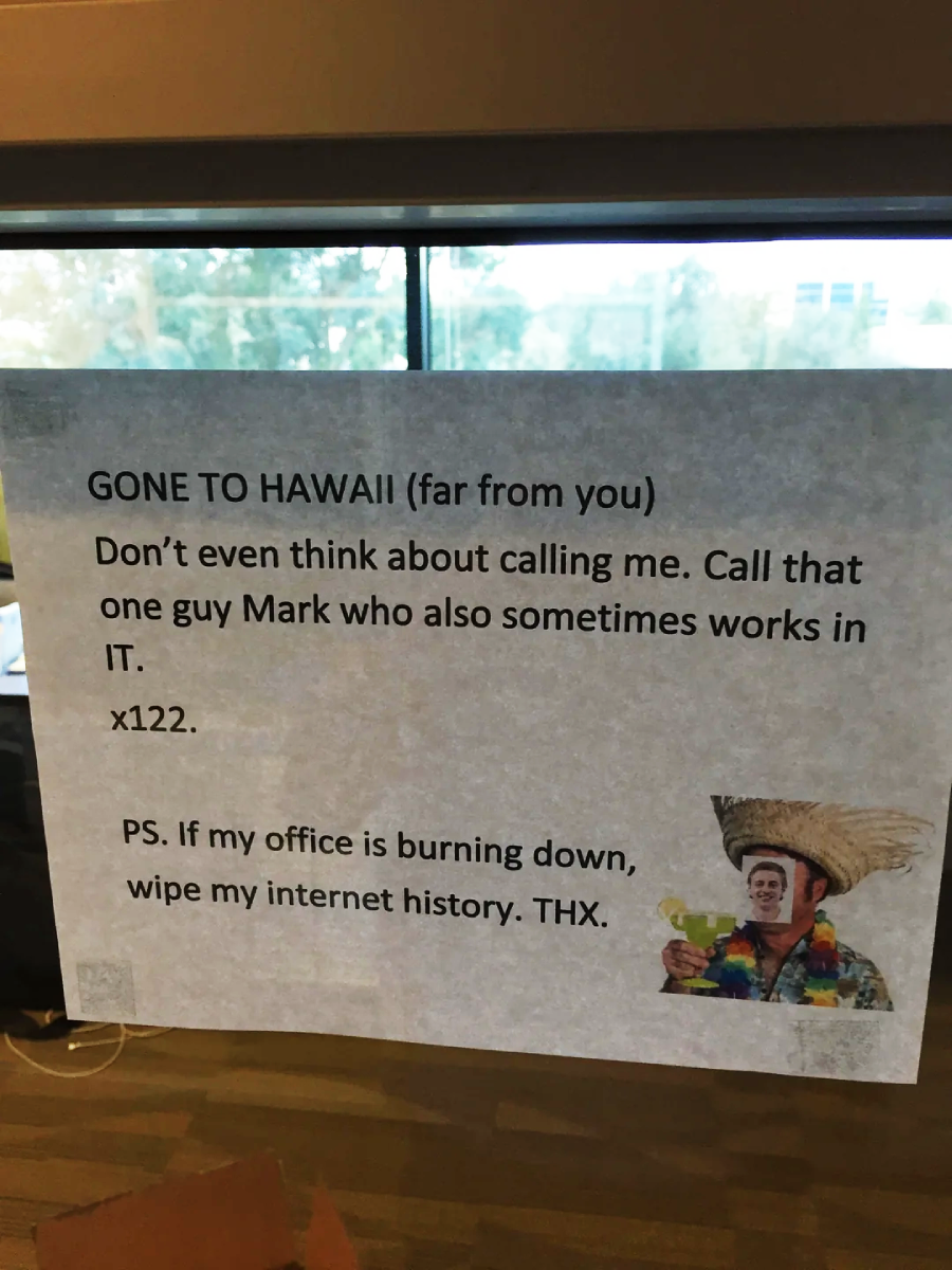 A printed sign on a window reads: “GONE TO HAWAII (far from you) Don’t even think about calling me. Call that one guy Mark who also sometimes works in IT. x122. PS. If my office is burning down, wipe my internet history. THX.” A small, humorous image of a man in a sombrero and colorful shirt is in the bottom right corner.