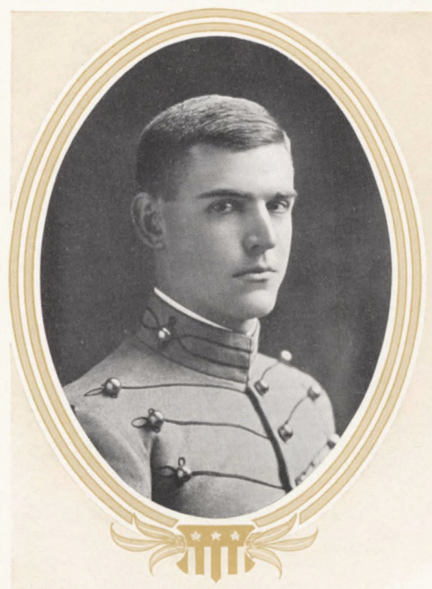 A young man in a West Point military cadet uniform poses for a formal black-and-white portrait, framed by an ornate oval border with a decorative emblem at the bottom.
