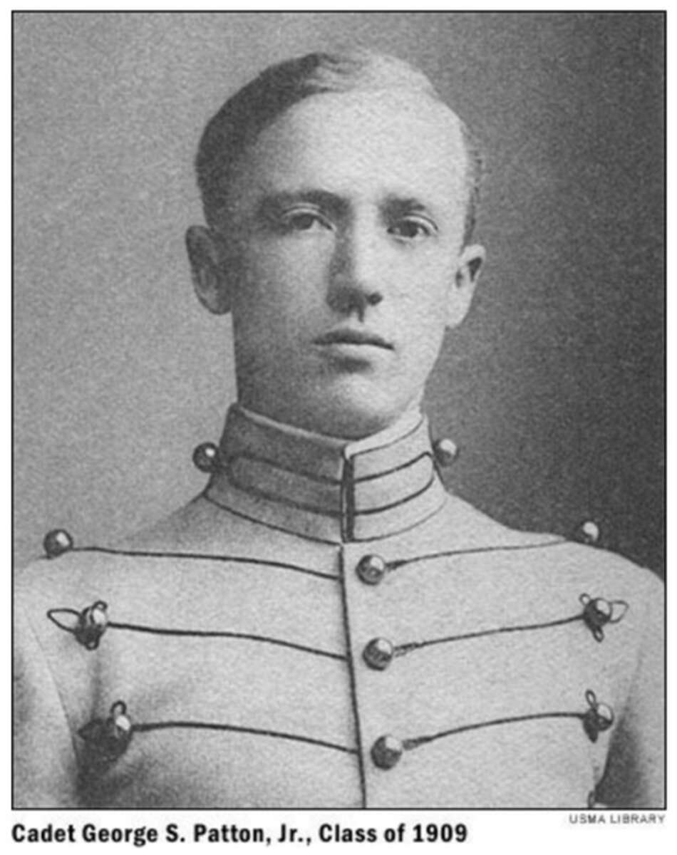 A young man in a formal military cadet uniform poses for a black-and-white portrait. The caption reads "Cadet George S. Patton, Jr., Class of 1909.