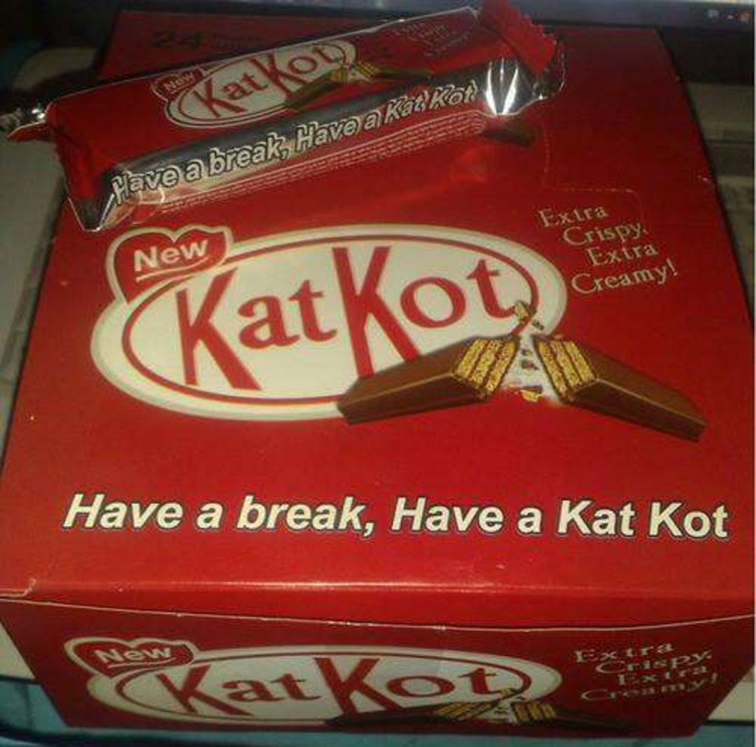 A red box and a matching wrapper labeled "Kat Kot," both featuring images of chocolate wafer bars. The text on the box says "Have a break, Have a Kat Kot" and "Extra Crispy. Extra Creamy!