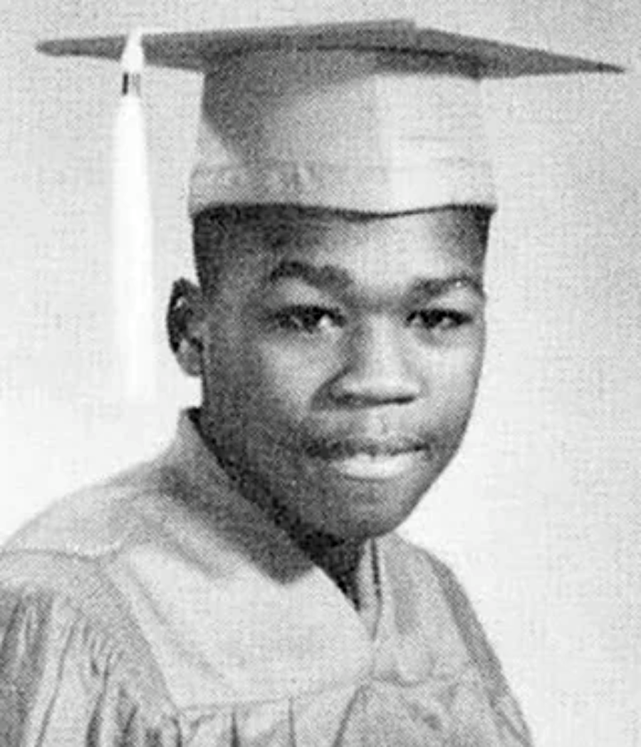 A young person wearing a graduation cap and gown looks at the camera in a black-and-white portrait, likely taken for a yearbook or graduation photo.