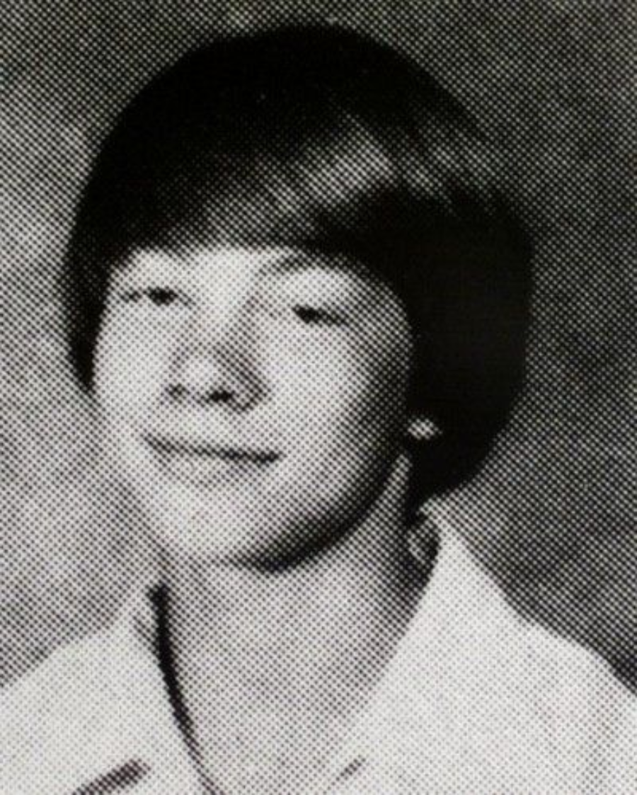 Black and white yearbook photo of a young person with straight, medium-length hair, wearing a collared shirt and smiling slightly, facing the camera against a plain background.