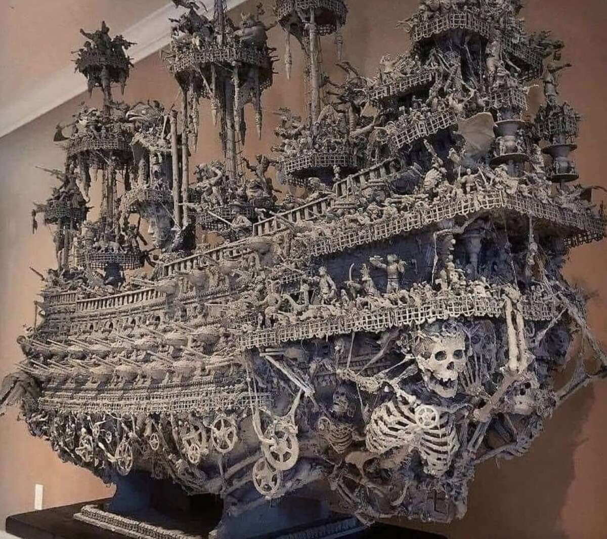 A large, detailed model of a ghostly pirate ship made from what looks like bones and skeletons, featuring skulls, skeleton figures, and intricate, gothic structures throughout the vessel.
