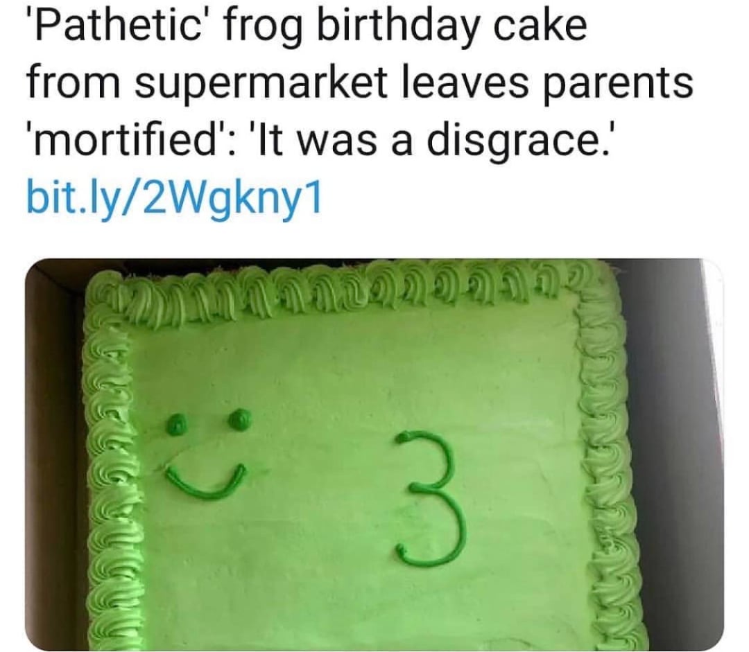 A rectangular green cake with piped green icing around the edges and a simple frosted smiley face: two dots and a curved line for a mouth, next to a number three. A headline above calls the cake "pathetic" and a "disgrace.