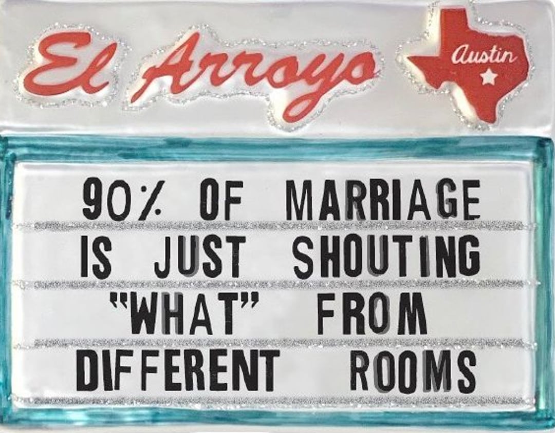 A restaurant sign reads: "90% of marriage is just shouting 'WHAT' from different rooms." The sign is labeled "El Arroyo" with a red Texas shape and "Austin" written inside.