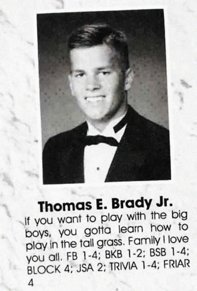 A young man wearing a tuxedo and bow tie smiles in a black-and-white yearbook photo. Below, the name "Thomas E. Brady Jr." appears with sports, clubs, and a quote about playing with the big boys.