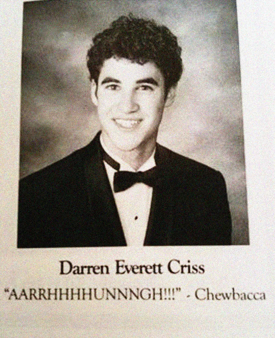 A young man with curly dark hair wears a tuxedo and smiles in a formal yearbook photo. Below, the name "Darren Everett Criss" appears with the quote: "'AARRHHHHUNNNGH!!!' - Chewbacca".