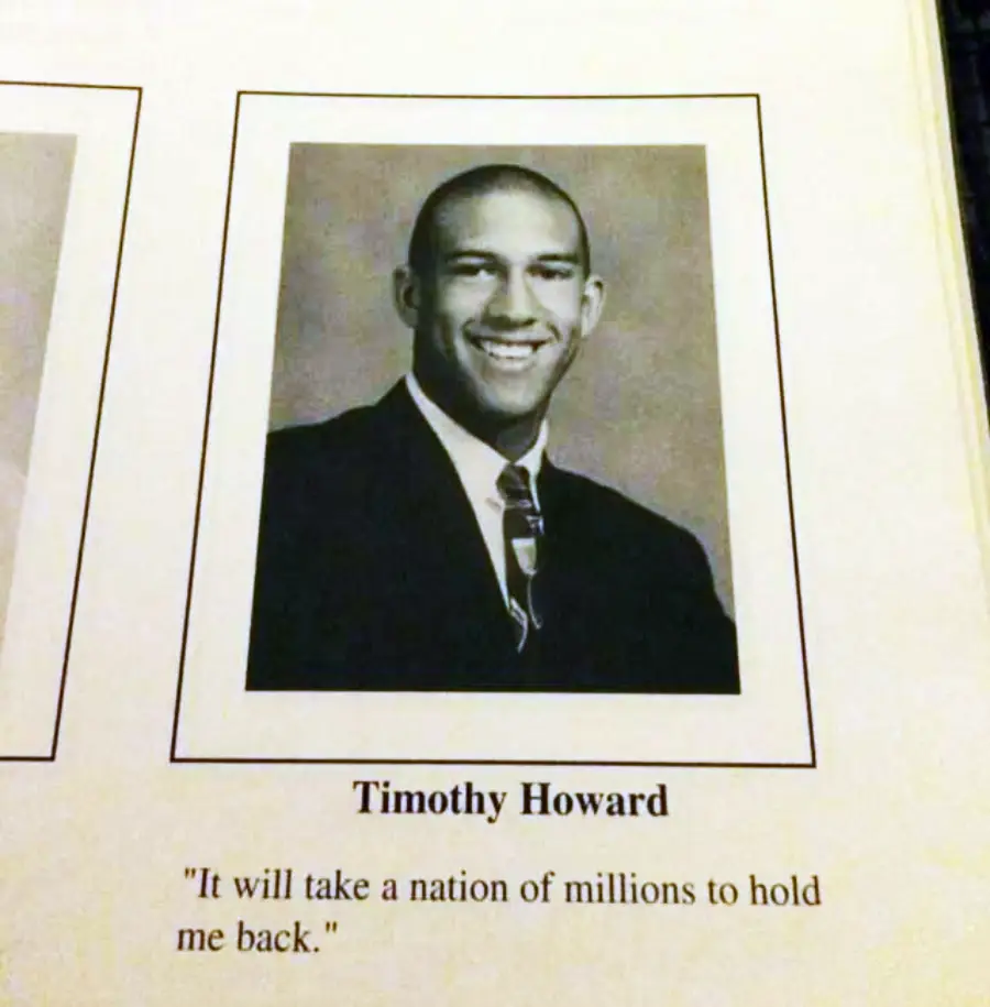 Black and white yearbook photo of a young man in a suit and tie, smiling at the camera. Text below reads “Timothy Howard” and the quote: “It will take a nation of millions to hold me back.”