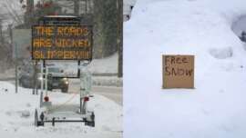 A road sign in the snow warns, "THE ROADS ARE WICKED SLIPPERY!!" Next to it, a snow-covered yard displays a cardboard sign that reads, "Free Snow.