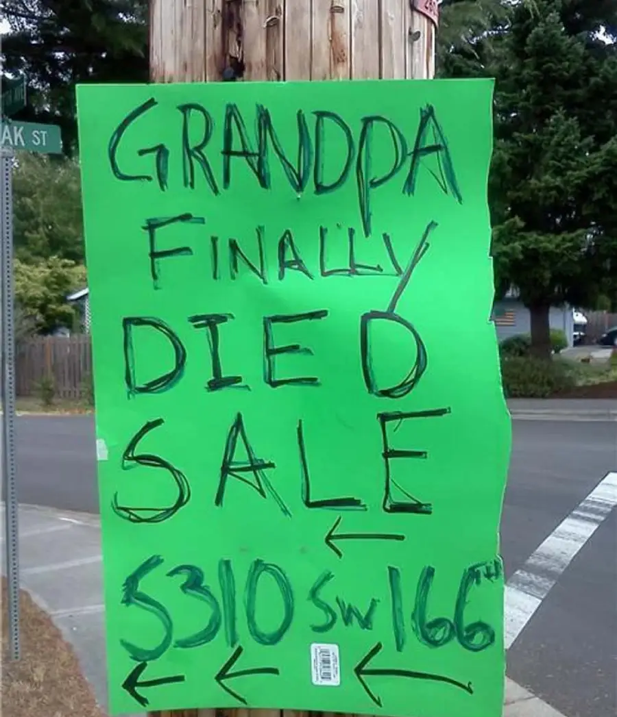 A bright green handwritten sign taped to a utility pole reads, “GRANDPA FINALLY DIED SALE,” with an address and arrows pointing both directions. The sign is by a street corner with trees and houses in the background.